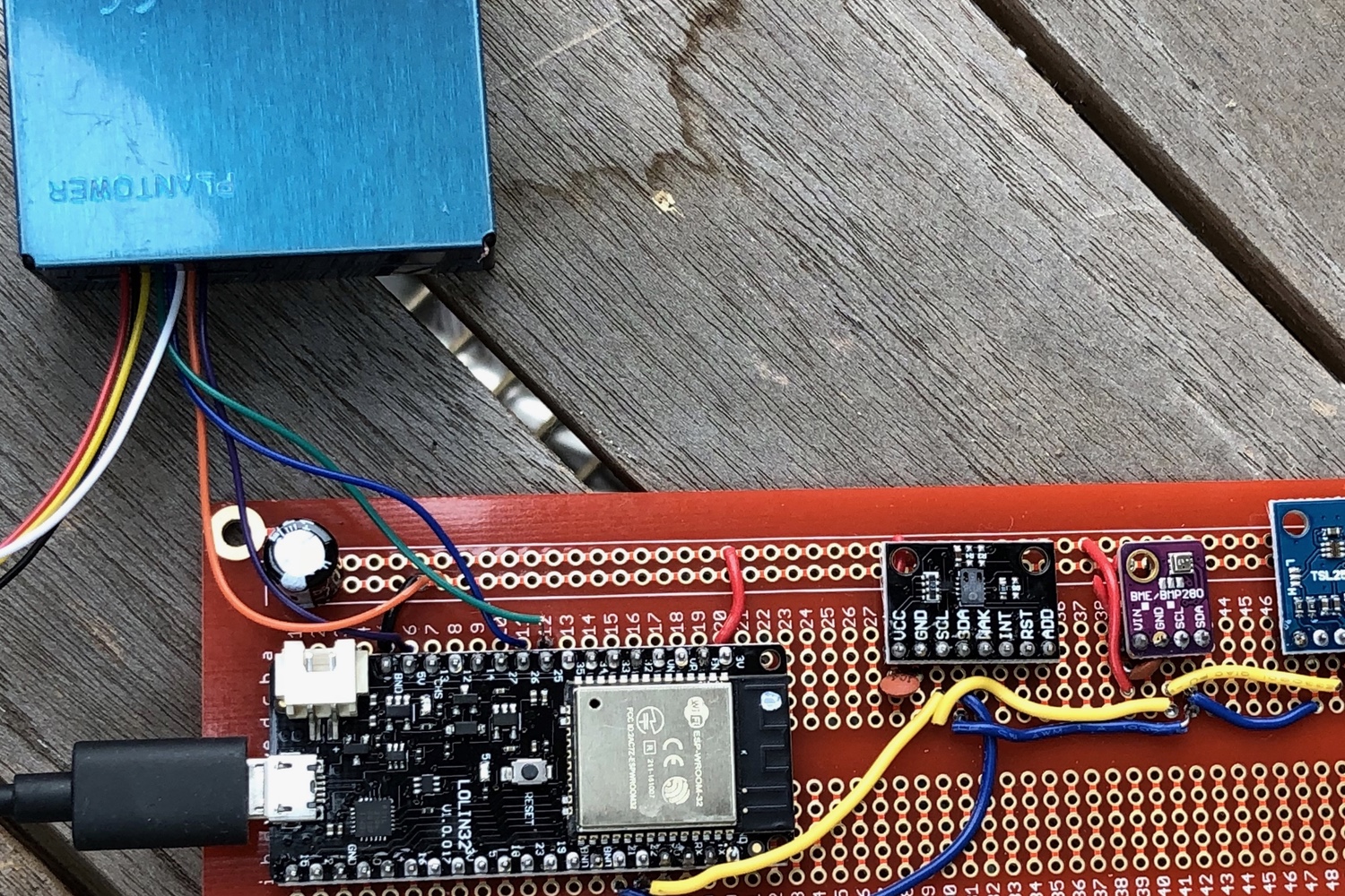 circuit board with Plantower particle sensor attached